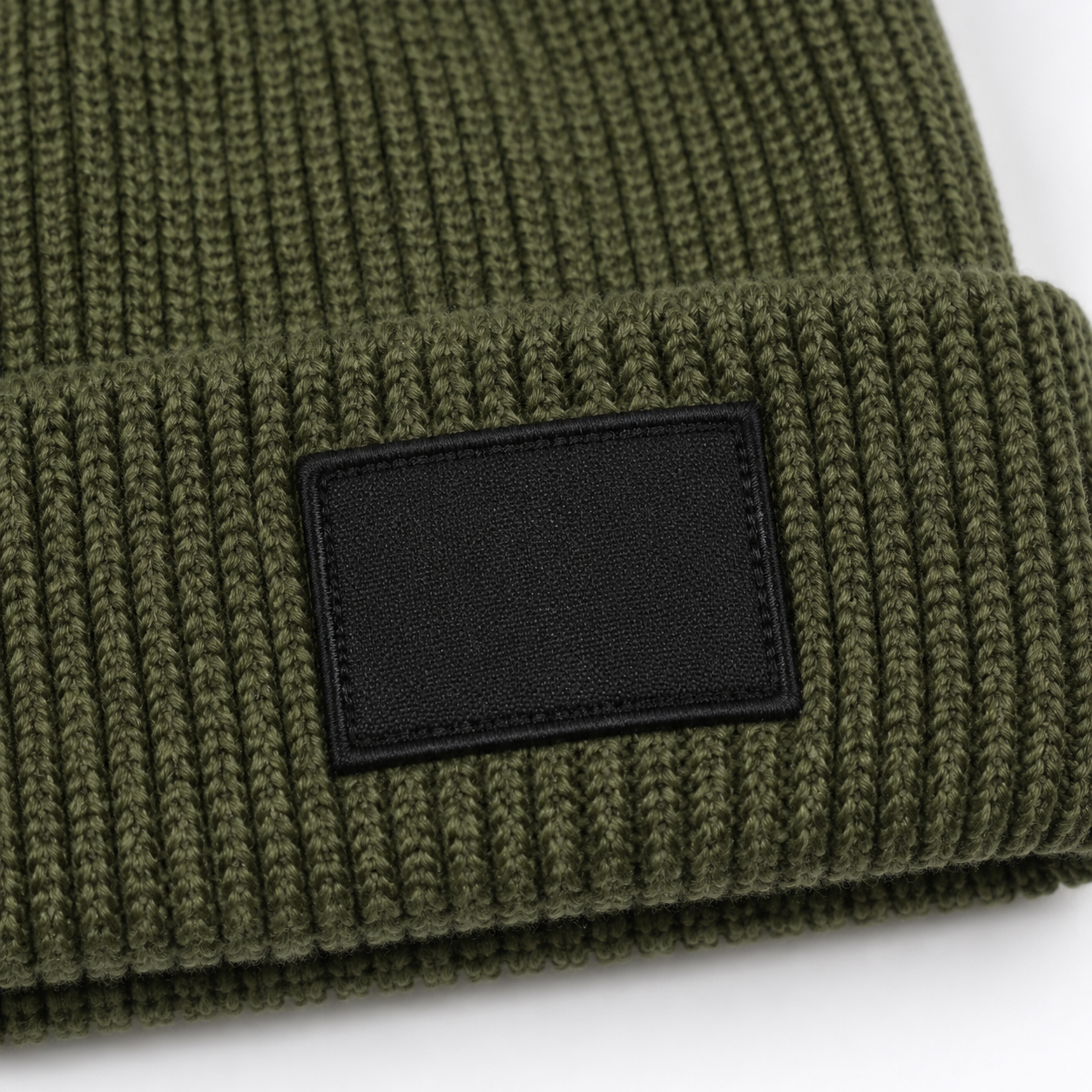 Knitted beanie woven label patch attachment detail close-up