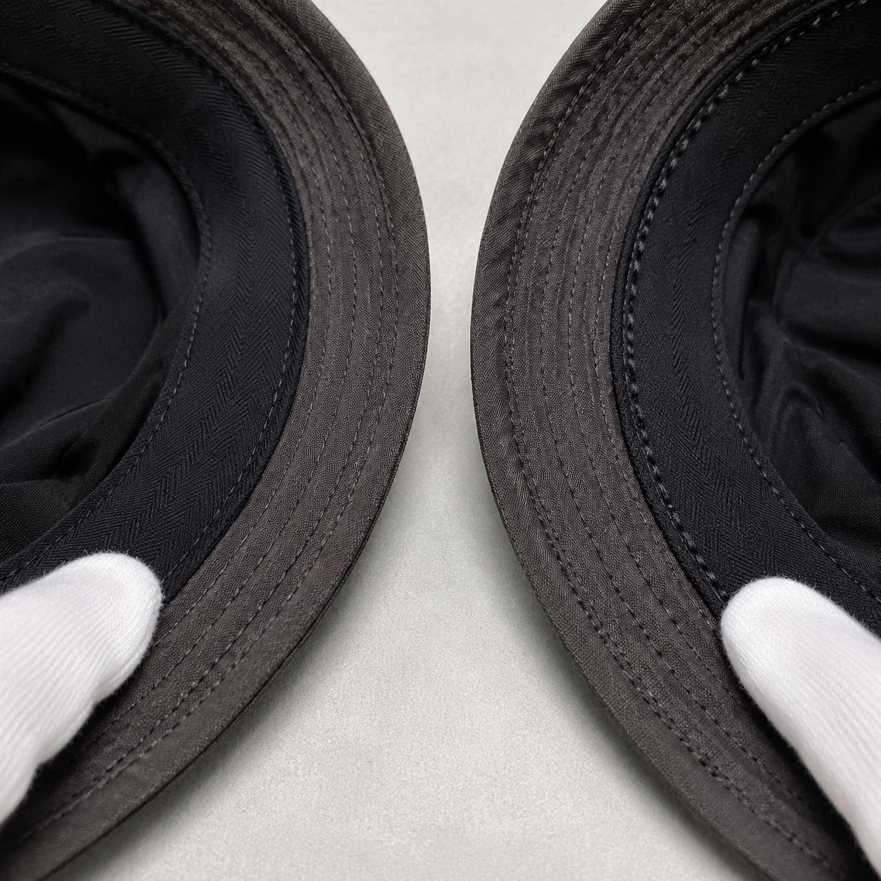 Close-up detail of bucket hat sweatband stitching quality blind stitch vs full stitch-through for wholesale