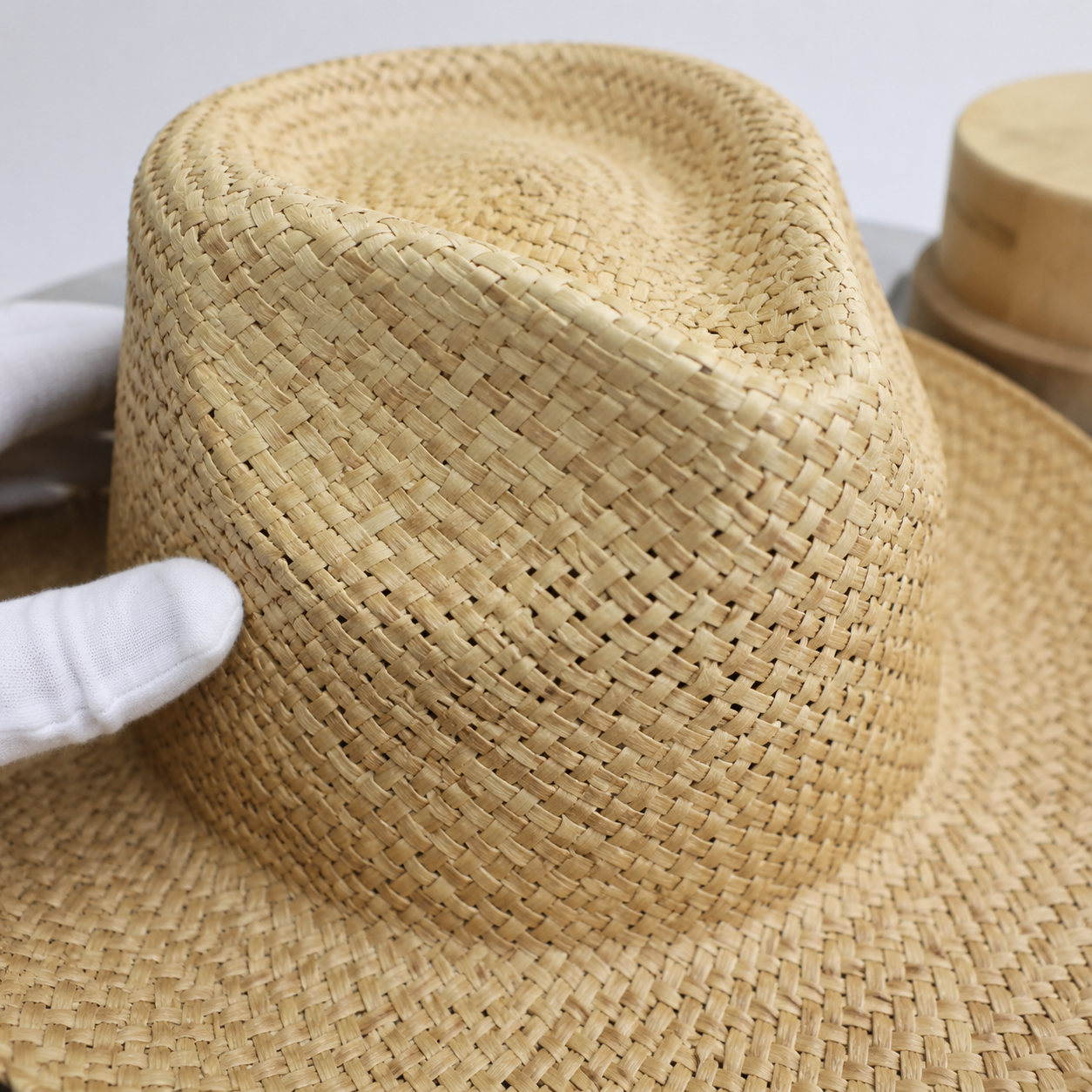 Straw hat crown blocking process on heated form for shape retention in wholesale manufacturing